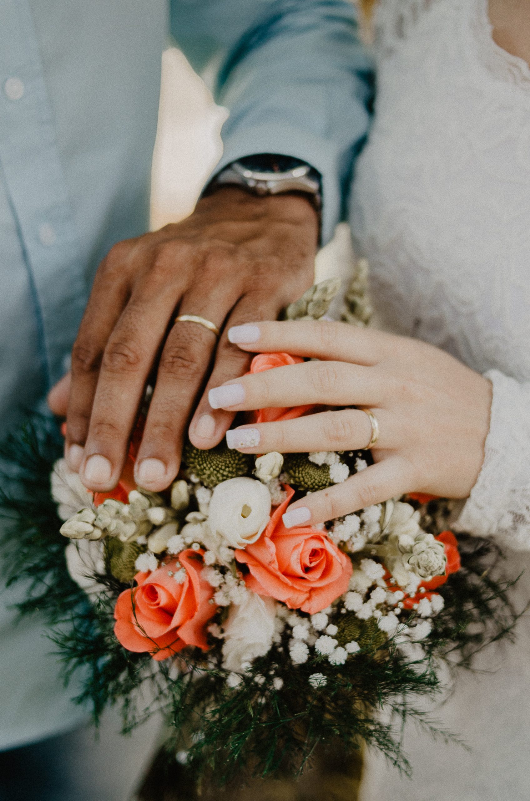 Man and woman s hands on top of ball bouquet