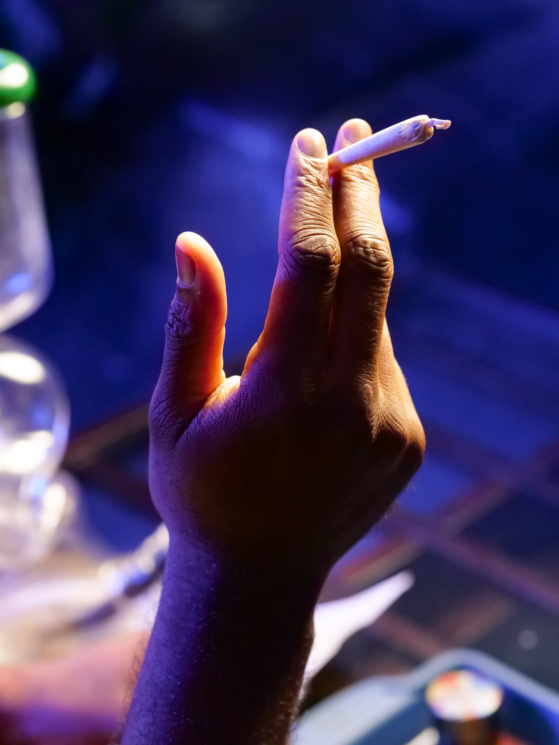 Photo of person holding blunt made of weed