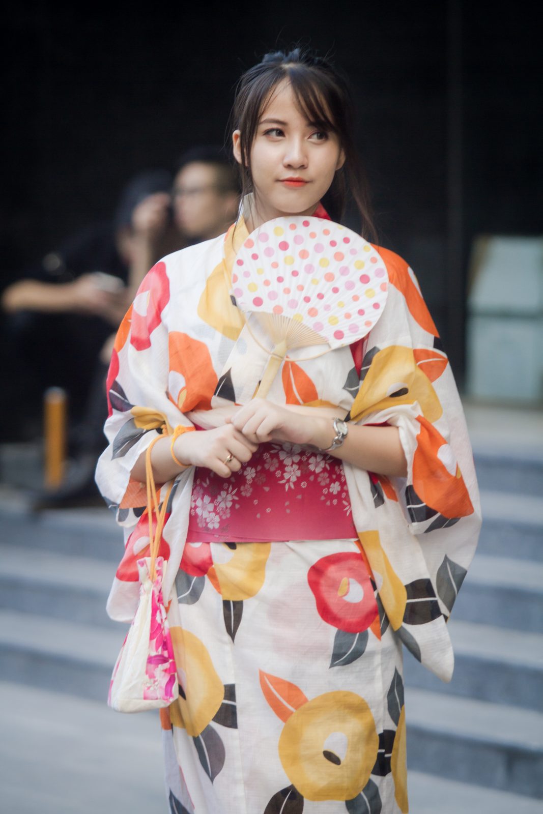 Woman wearing kimono holding fan