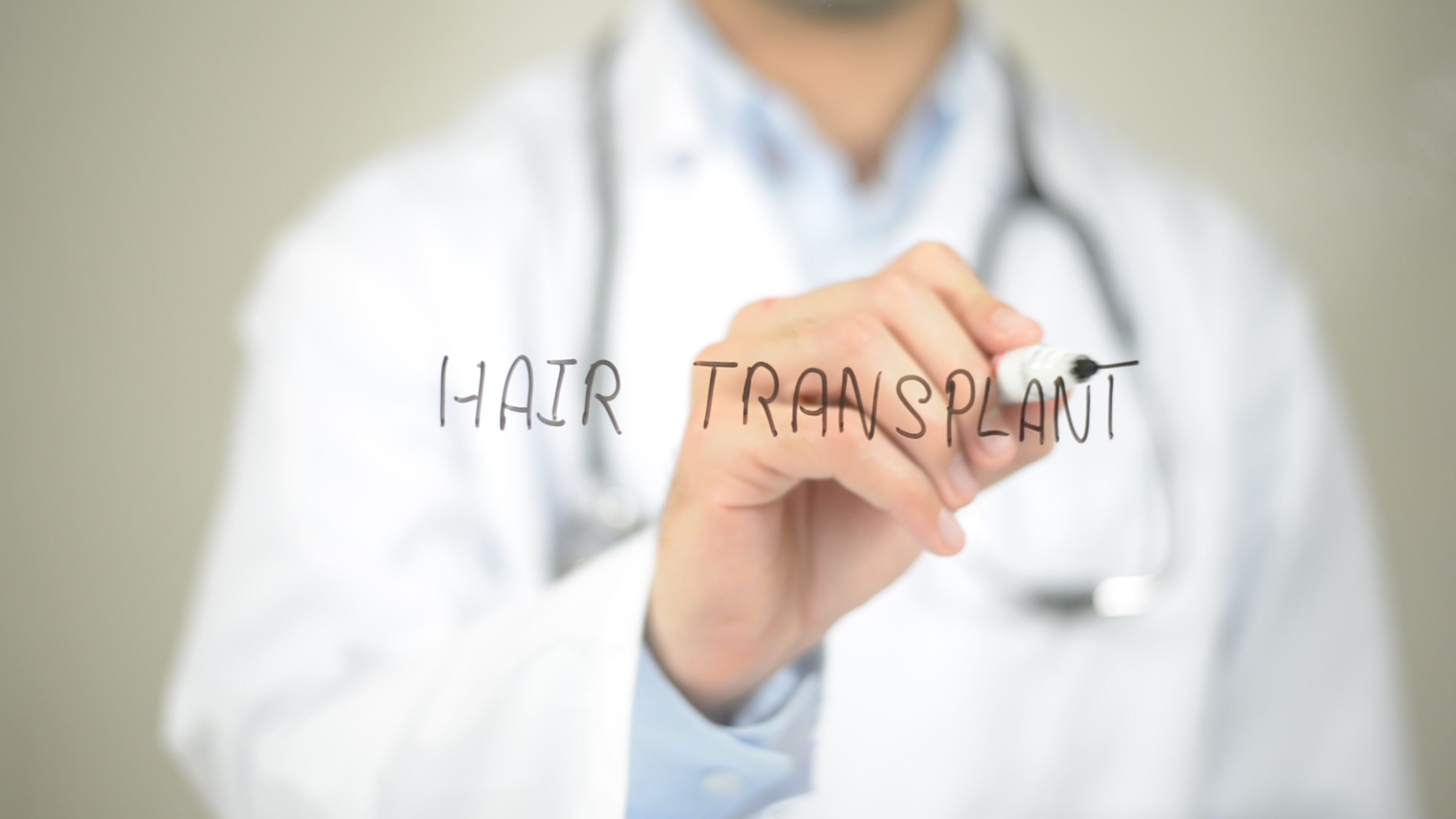 Hair Transplant , Doctor writing on transparent screen