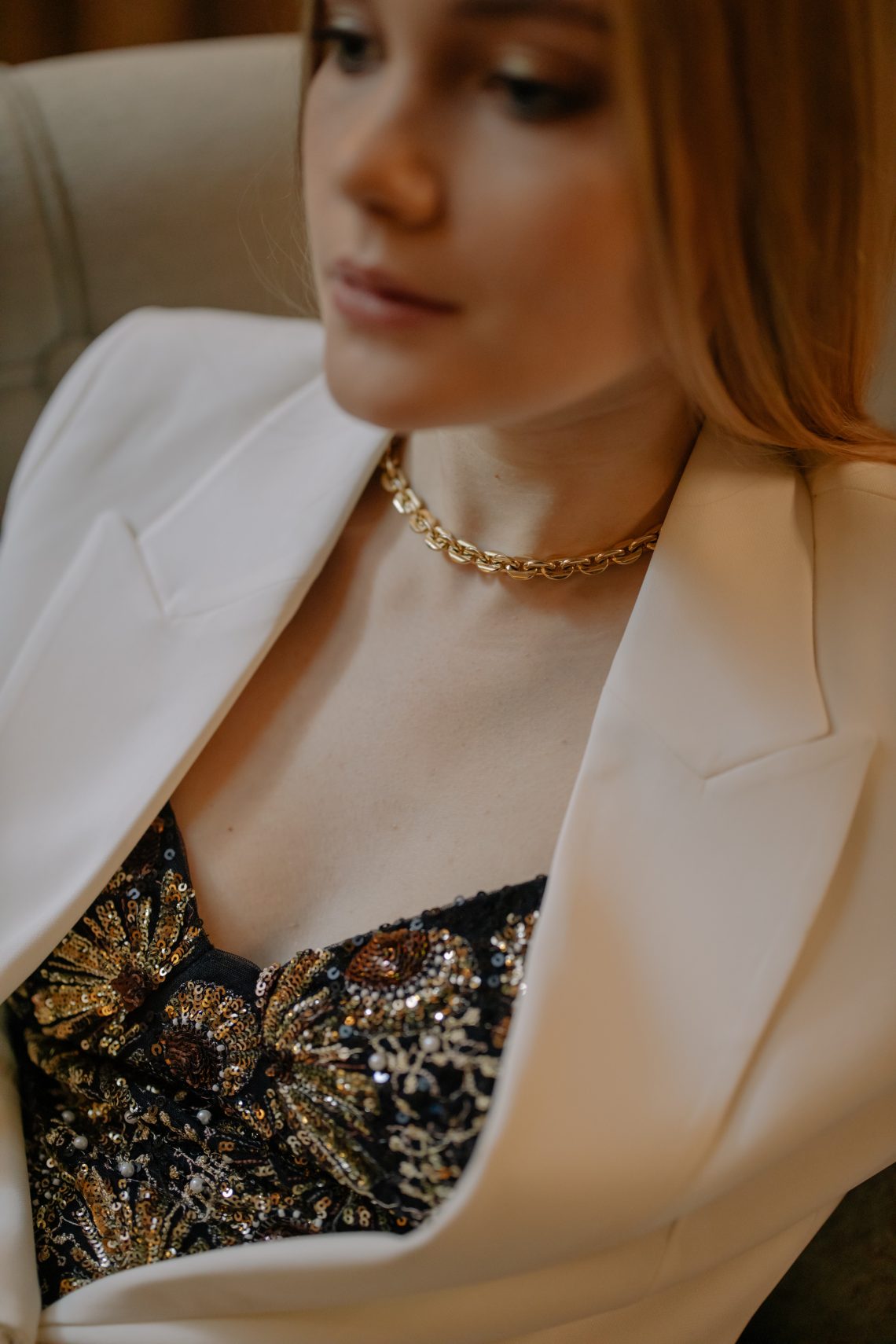 Photo of a woman wearing gold chain necklace