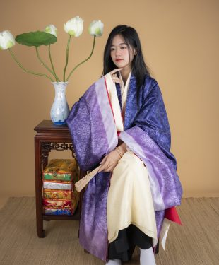 Woman in kimono sitting on chair