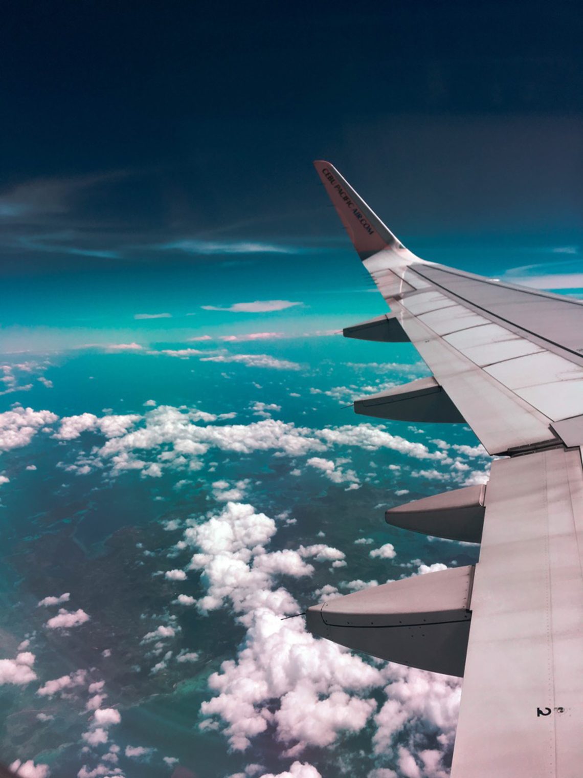 Airplane wing above clouds