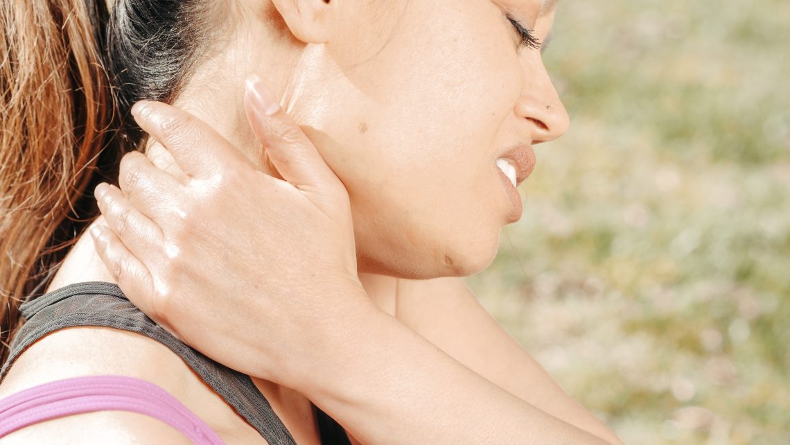Close up photo of woman having a neck pain