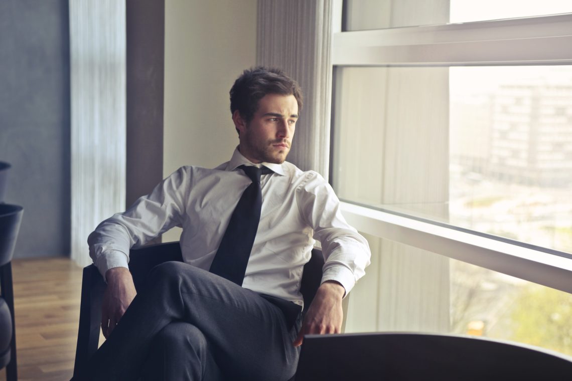Man wearing white dress shirt and black necktie