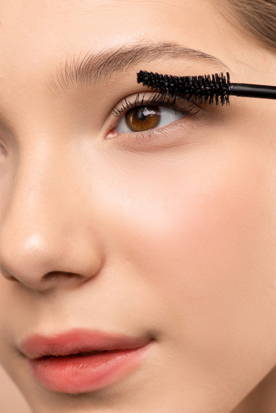 Woman applying mascara