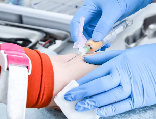 Nurse takes blood from a vein for analysis.