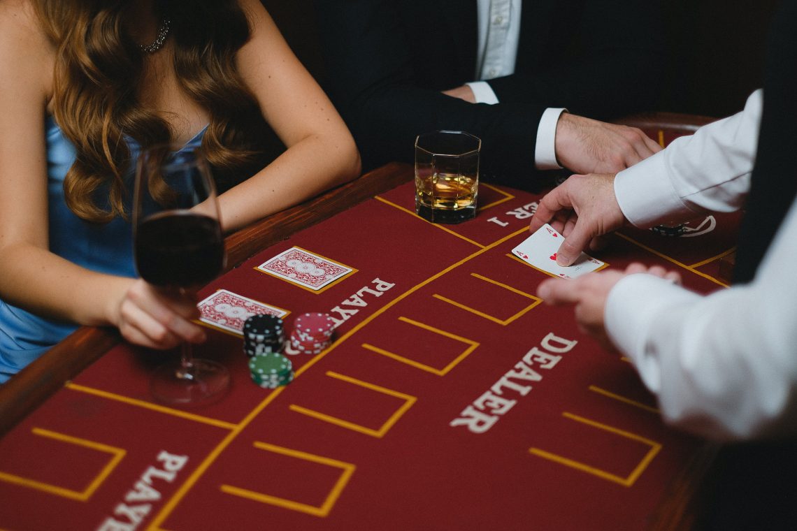 A card dealer holding a card in front of the players