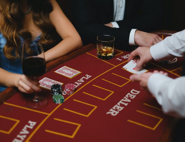 A card dealer holding a card in front of the players