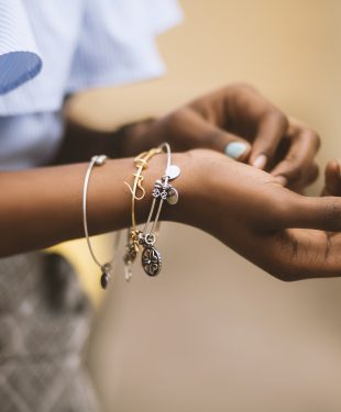 Selective focus photography of person wearing three bangles