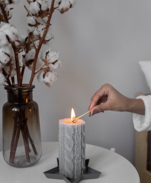 Close up shot of a person lighting a candle