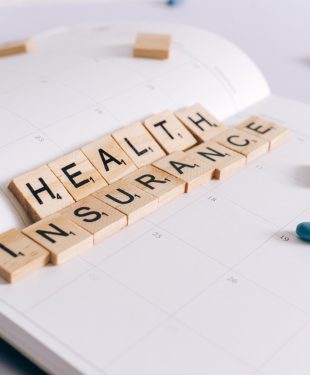 Health insurance scrabble tiles on planner