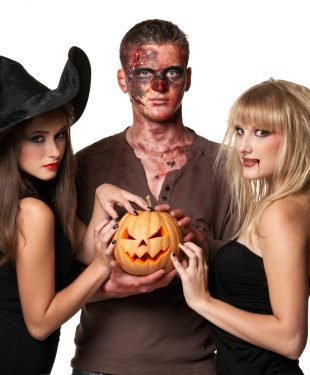 vampire, zombie and witch holding a pumpkin