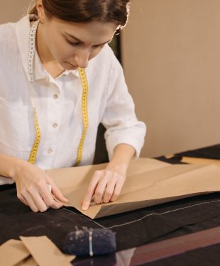 Woman putting a pattern on a black fabric