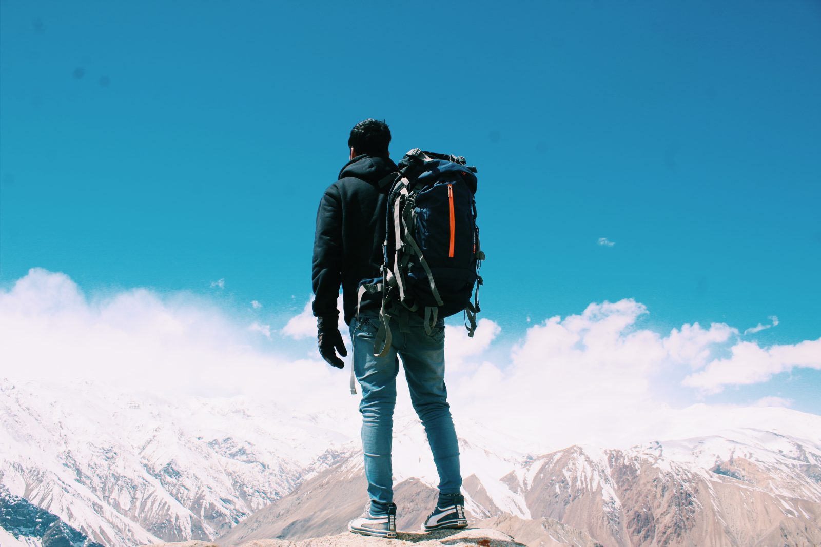 Photo of man standing on top of mountain