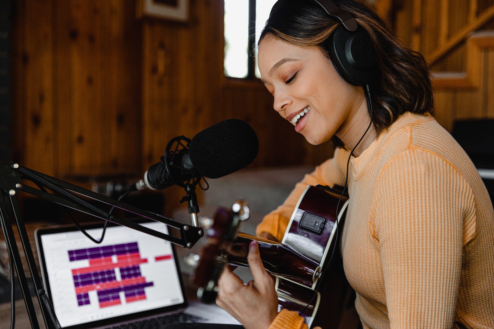 woman in brown sweater wearing headphones