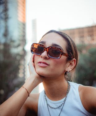 Portrait of a woman in sunglasses in city