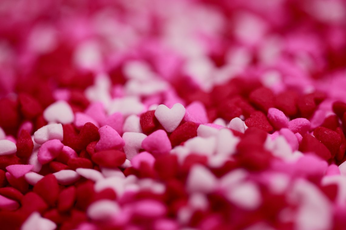 Close up shot of tiny heart shaped sugar candy sprinkles.