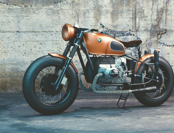 Orange and black bmw motorcycle before concrete wall