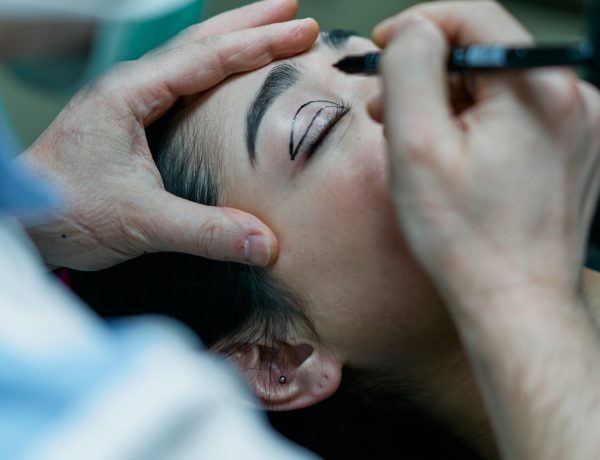 A surgeon marking a patient s eyelid