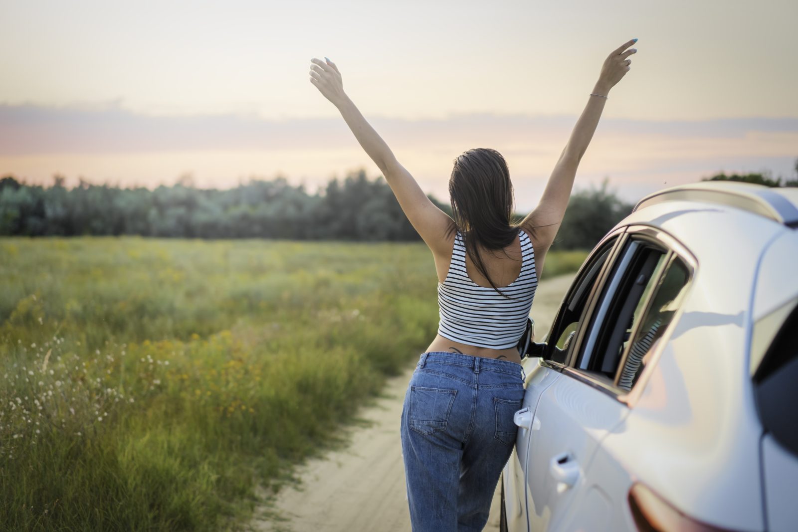 Woman leaning beside vehicle