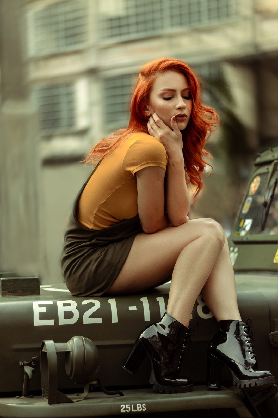 Woman sitting on vehicle hood