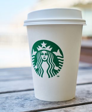 Closed white and green starbucks disposable cup