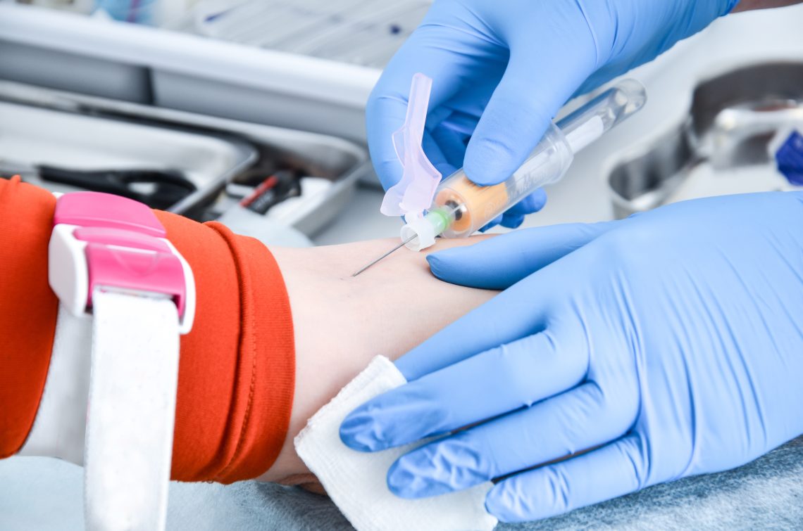 Nurse takes blood from a vein for analysis.