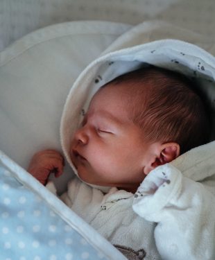Baby in white and blue blanket