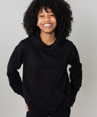 Delighted black woman in hoodie
