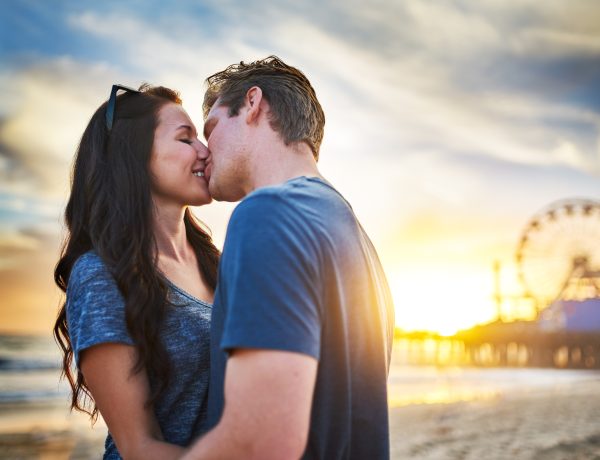 happy couple kissing on beach